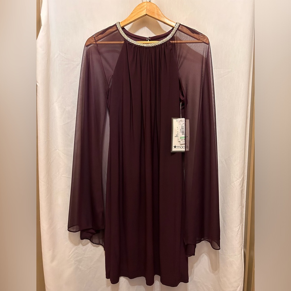 Womens cocktail dress.  Sleeveless sheath covered by a sheer cape.  Back zip.